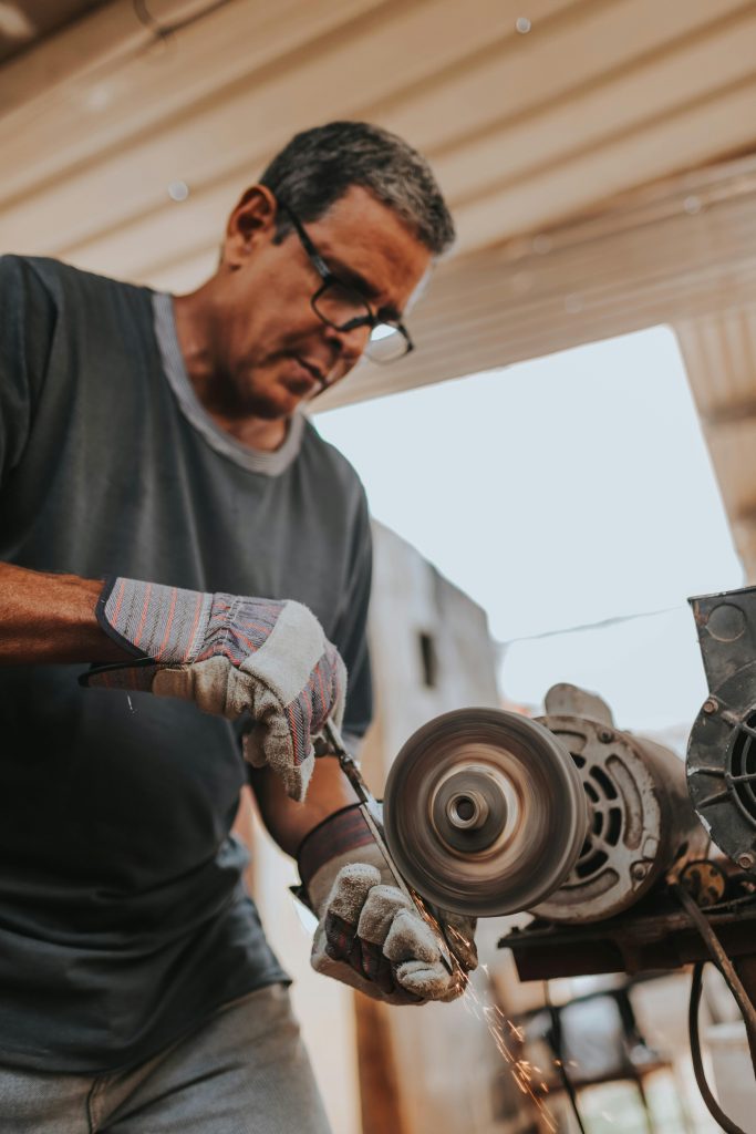 Man Grinding Metal Rod. Credits: Luis Quintero via Pexels