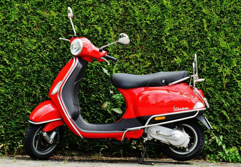 Red and Black Moped Scooter Beside Green Grass. Credits: Pixabay