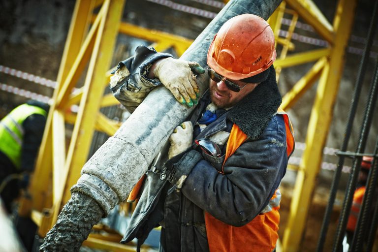 Man Carrying Gray Pipe. Credits: Yury Kim via Pexels