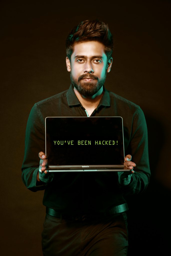 A person holding a laptop with a bold "You've Been Hacked!" message on the screen. This image highlights the importance of cybersecurity awareness, hacking protection, and implementing measures to safeguard personal information online. Perfect for content focused on online safety, cybersecurity insurance, and combating cyber threats.